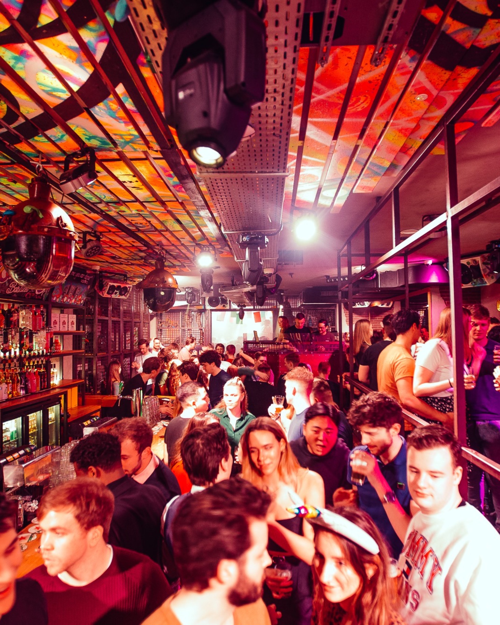 Shots at the bar under red lights at Bar Bascule